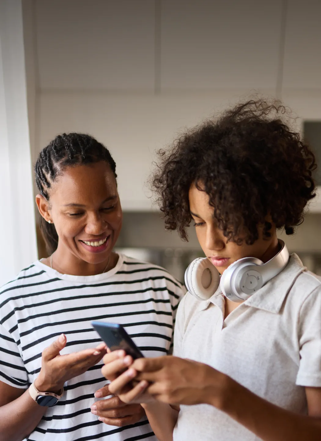 Mother and son looking at a phone together